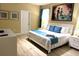Bright bedroom with king bed, blue accents, and artwork at 1466 Moon Valley Dr, Champions Gate, FL 33896
