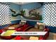 The room has a whimsical Mario Kart-themed decor, complete with race car beds for a fun and imaginative space at 1466 Moon Valley Dr, Champions Gate, FL 33896