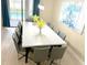 Open dining area with a large table, seating for ten, and access to the pool area at 1466 Moon Valley Dr, Champions Gate, FL 33896