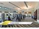 Well-equipped fitness center with various exercise machines and ample natural light from large windows at 1466 Moon Valley Dr, Champions Gate, FL 33896