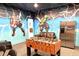 Fun game room with foosball table, mini-fridge, and themed decor at 1466 Moon Valley Dr, Champions Gate, FL 33896