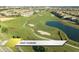 Picturesque aerial shot of the community golf course featuring well-manicured greens and water hazards at 1466 Moon Valley Dr, Champions Gate, FL 33896