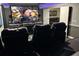 Home theater room offers large screen and tiered seating for perfect movie viewing at 1466 Moon Valley Dr, Champions Gate, FL 33896