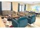 Inviting living room with two sofas, two armchairs, area rug, and access to the dining room at 1466 Moon Valley Dr, Champions Gate, FL 33896