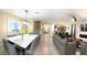 Open-concept living space with dining area, comfortable seating, and modern kitchen at 1466 Moon Valley Dr, Champions Gate, FL 33896