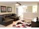 Upstairs loft area with a dark sectional couch, ceiling fan and natural light at 1466 Moon Valley Dr, Champions Gate, FL 33896