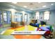 playroom with tables, chairs, and colorful soft flooring at 1466 Moon Valley Dr, Champions Gate, FL 33896