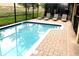 A gorgeous in-ground pool with brick pavers and lounge chairs, perfect for relaxing at 1466 Moon Valley Dr, Champions Gate, FL 33896