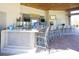 The tiki bar features a well-stocked counter with modern appliances, offering a fun and casual atmosphere at 1466 Moon Valley Dr, Champions Gate, FL 33896