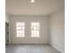 Bedroom featuring two windows letting in natural light and light, wood-look floors at 16600 Sw 23Rd Avenue Rd, Ocala, FL 34473