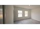 Bedroom featuring two windows letting in natural light and light, wood-look floors at 16600 Sw 23Rd Avenue Rd, Ocala, FL 34473