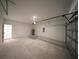 Well-lit garage with ample space for parking and storage, featuring convenient access doors at 16600 Sw 23Rd Avenue Rd, Ocala, FL 34473