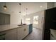 Kitchen includes stainless appliances, white cabinets, granite counters and a kitchen island at 16600 Sw 23Rd Avenue Rd, Ocala, FL 34473
