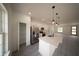 Bright, modern kitchen with stainless steel appliances, a large island, and sleek pendant lighting at 16600 Sw 23Rd Avenue Rd, Ocala, FL 34473