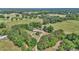 Aerial shot showcasing the home's expansive acreage, surrounded by lush green trees at 2299 Nw 135Th Ln, Citra, FL 32113