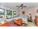 Charming bedroom with a large window seat, ceiling fan, and bright, comfortable decor at 2299 Nw 135Th Ln, Citra, FL 32113