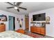 Bedroom with dresser, TV, decorative mirror, and access to other areas of the home at 2299 Nw 135Th Ln, Citra, FL 32113
