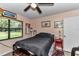Cozy bedroom with a ceiling fan, natural light, and a serene ambiance for restful nights at 2299 Nw 135Th Ln, Citra, FL 32113