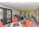 Charming covered patio featuring brick flooring, black trim door, string lights, and outdoor seating at 2299 Nw 135Th Ln, Citra, FL 32113