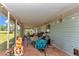 Relaxing covered patio with screened enclosure, brick flooring, string lights, and outdoor seating area at 2299 Nw 135Th Ln, Citra, FL 32113