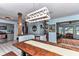 Open-concept dining space with custom wood accents, modern lighting, and views into the living area at 2299 Nw 135Th Ln, Citra, FL 32113