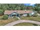 Charming single-story home with a well-maintained lawn, mature trees, and an inviting entrance at 2299 Nw 135Th Ln, Citra, FL 32113