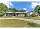 Charming home featuring a well-manicured lawn, trees and a welcoming facade at 2299 Nw 135Th Ln, Citra, FL 32113