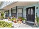 Charming front porch featuring a cozy seating area, potted plants, and decorative elements at 2299 Nw 135Th Ln, Citra, FL 32113