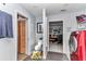 Bright laundry room with a modern red washer and dryer, leading to the living room at 2299 Nw 135Th Ln, Citra, FL 32113