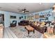 Spacious living room features a ceiling fan, a patterned rug, and comfortable seating at 2299 Nw 135Th Ln, Citra, FL 32113