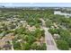 Sprawling aerial view of the neighborhood with mature trees, a winding road, and homes near a scenic lake at 2312 Corrine Dr, Orlando, FL 32803