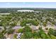 Beautiful aerial view of a residential neighborhood surrounded by mature trees and a lake, showcasing the tranquil setting at 2312 Corrine Dr, Orlando, FL 32803