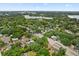 Aerial view of a charming neighborhood with tree-lined streets, lush greenery, and homes near a serene lake at 2312 Corrine Dr, Orlando, FL 32803