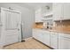 Kitchen featuring white cabinets, countertops, tile floors, and an abundance of natural light at 2312 Corrine Dr, Orlando, FL 32803