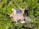 Aerial view of a home that features a screened pool enclosed by a forest, providing privacy and natural beauty at 2705 Curryville Rd, Chuluota, FL 32766