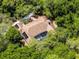 Aerial view of a home with a screened-in pool area, completely encompassed by a forest of green trees, and landscaping at 2705 Curryville Rd, Chuluota, FL 32766
