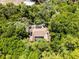 Bird's-eye view of a house with screened lanai, surrounded by lush trees and landscaping, creating a private oasis at 2705 Curryville Rd, Chuluota, FL 32766