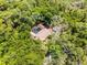 Aerial view of the home featuring a screened in pool and lush wooded acreage at 2705 Curryville Rd, Chuluota, FL 32766