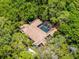 Aerial view of a single-Gathering home featuring a screened-in pool, surrounded by lush landscaping for enhanced privacy at 2705 Curryville Rd, Chuluota, FL 32766