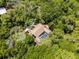 Aerial view of a beautiful house with a screened pool surrounded by a dense canopy of trees, offering privacy at 2705 Curryville Rd, Chuluota, FL 32766