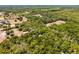 Aerial view of vast acreage surrounded by mature trees, showcasing a private and serene country setting at 2705 Curryville Rd, Chuluota, FL 32766