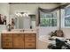 Bathroom featuring double sinks, a garden tub, and decorative accents for a relaxing atmosphere at 2705 Curryville Rd, Chuluota, FL 32766