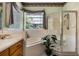Bright bathroom showcases a tub, glass shower, and window views at 2705 Curryville Rd, Chuluota, FL 32766