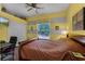 Comfortable bedroom featuring yellow and grey walls, a window, and a ceiling fan, ideal for rest and relaxation at 2705 Curryville Rd, Chuluota, FL 32766