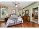 A comfortable bedroom with hardwood floors, a ceiling fan, and a dresser at 2705 Curryville Rd, Chuluota, FL 32766