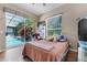 Bedroom featuring hardwood floors, a window overlooking the backyard pool, and neutral-toned walls at 2705 Curryville Rd, Chuluota, FL 32766