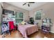 Bedroom with hardwood floors, a ceiling fan, and multiple windows allowing in natural light at 2705 Curryville Rd, Chuluota, FL 32766