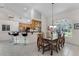 Bright dining area featuring tile floors, wainscotting, and an adjacent breakfast bar at 2705 Curryville Rd, Chuluota, FL 32766