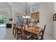 Bright dining area featuring tile floors, wainscotting, and an adjacent patio view at 2705 Curryville Rd, Chuluota, FL 32766