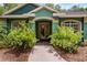 Inviting front entrance with lush landscaping and stone walkway, creating curb appeal at 2705 Curryville Rd, Chuluota, FL 32766